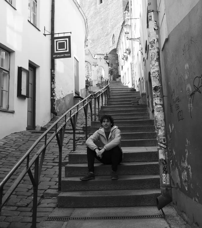 Henry Fisher sitting on old stone steps