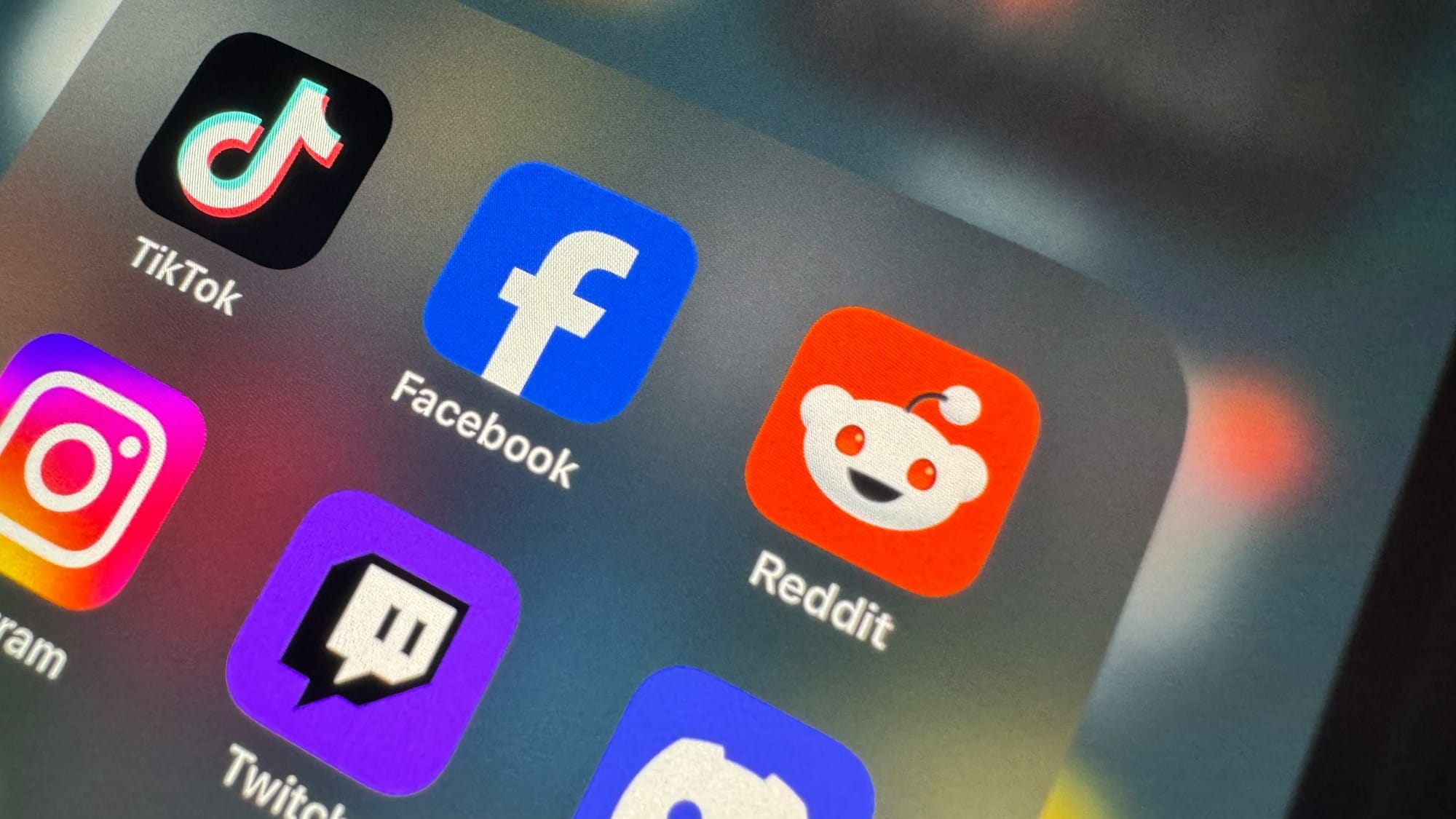 a close up of a cell phone with social icons on it